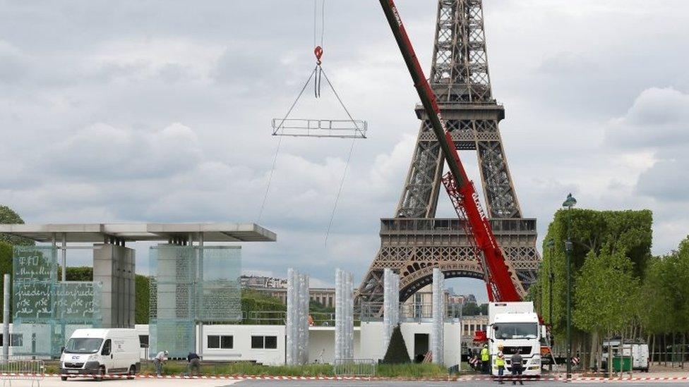 Workers build a fan zone near the Eiffel Tower in Paris. Photo: 9 May 2016