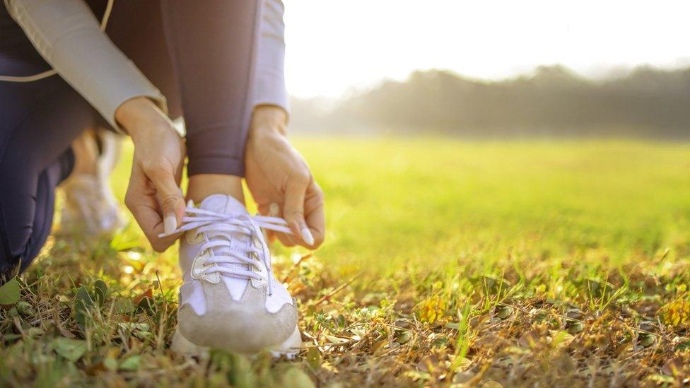 Runner tying her shoes