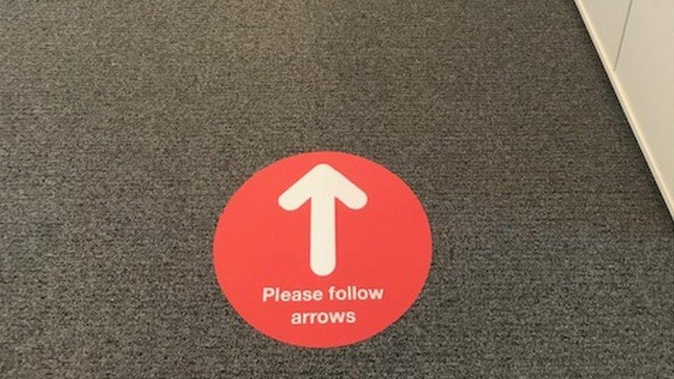 arrow sign on floor of Hugh James office