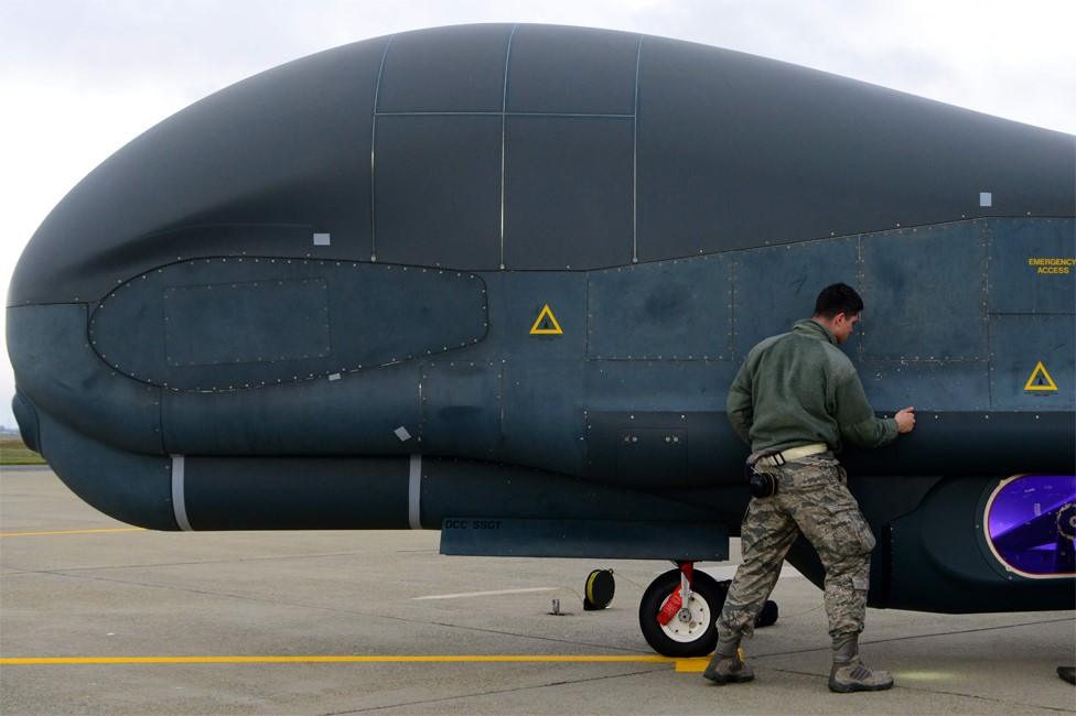 US Air Force Staff Sgt Seth Thurber checks panels of a RQ-4 Global Hawk unmanned surveillance drone during a pre-flight inspection on 5 February 2019, at Beale Air Force Base, California (5 February 2019)