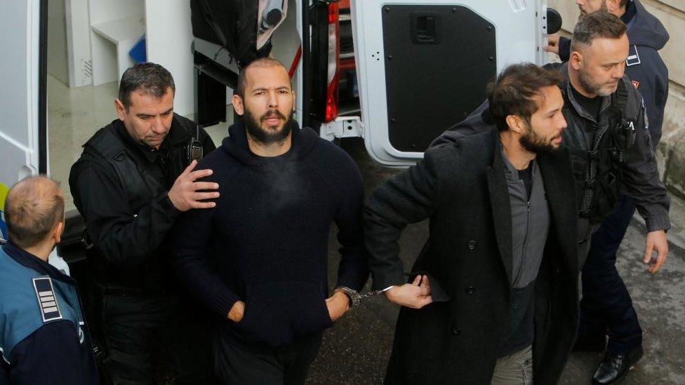 Andrew and Tristan Tate are escorted by police officers to the Bucharest Court of Appeal