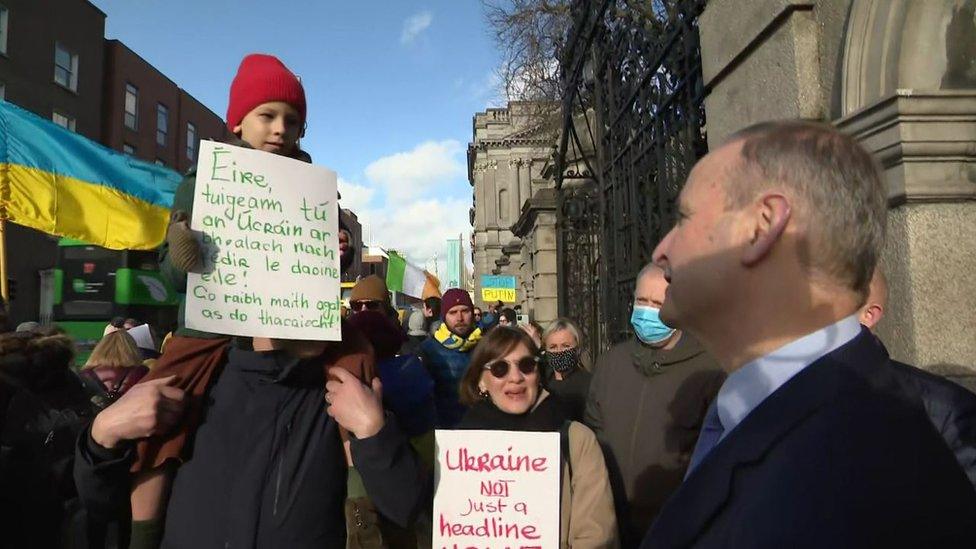 Protesters speak to Taoiseach Micheál Martin outside the Dáil