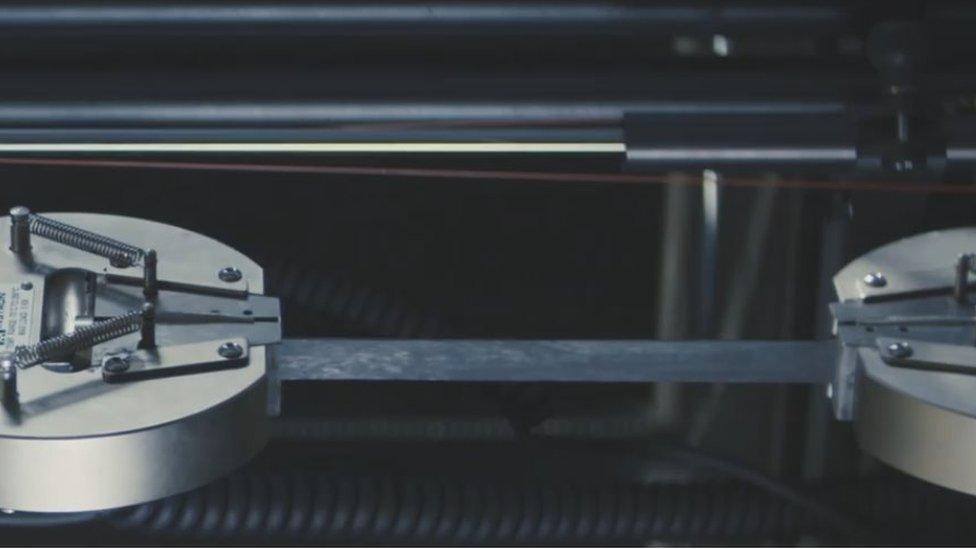 Graphene rubber being stretched and tested in the laboratory