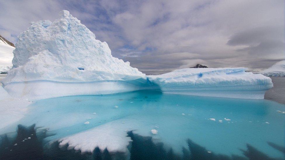 Bright white icebergs floating in the Southern Ocean close to the South Pole