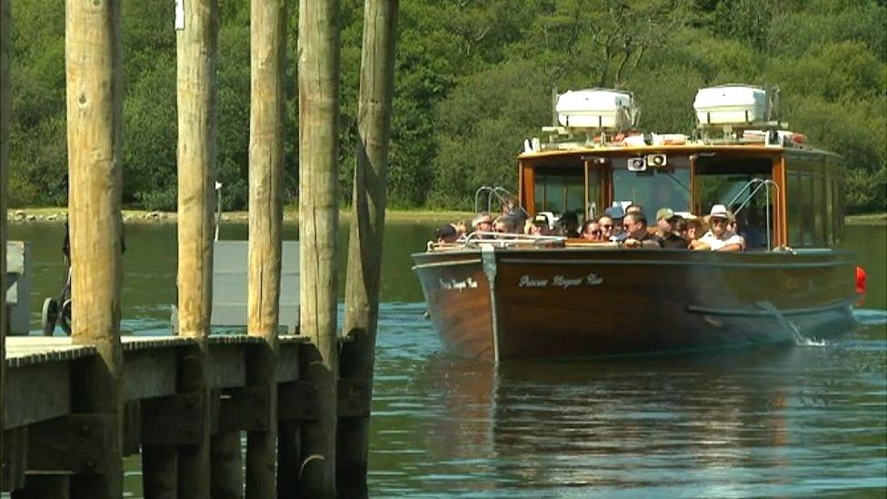 A boat approaches the docking platform in Keswick