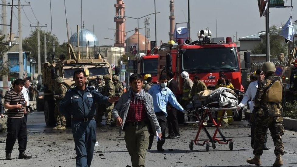 Medical staff carry a stretcher following a suicide car bomb attack that targeted foreign military vehicle in Kabul (11 October 2015)