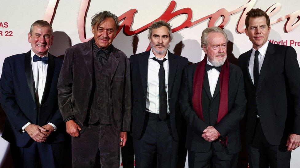 Mark Huffam, Dariusz Wolski, Joaquin Phoenix, Ridley Scott and Kevin Walsh pose together for pictures at the world premiere of Napoleon in Paris