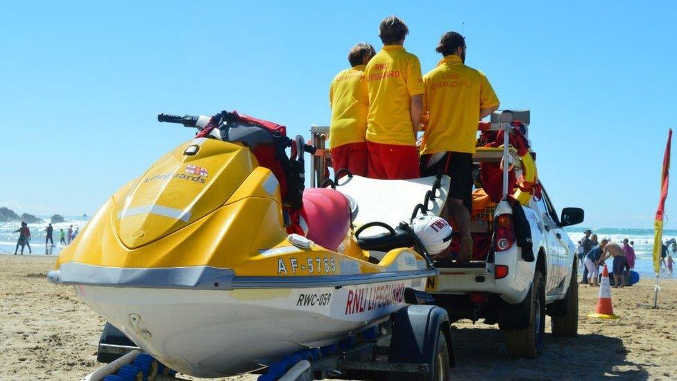 RNLI lifeguards patrolling a beach