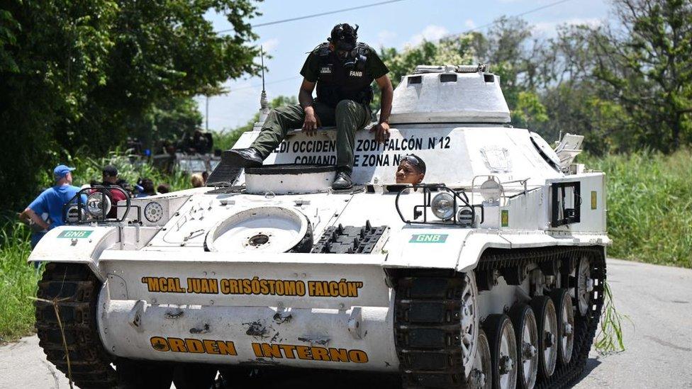 An armoured vehicle drives near the Tocoron prison after authorities seized control of the prison in Tocoron, Aragua State, Venezuela, on September 20, 2023.