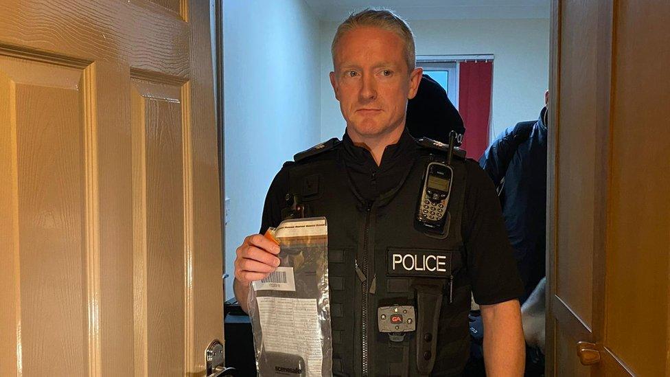 Sergeant Scott Minall with an evidence bag