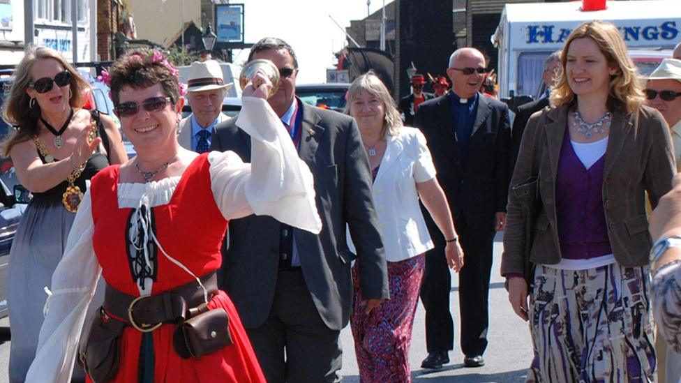 People take part in the opening parade of the annual Old Town Carnival at Hastings, England on July 30, 2011. Hastings M.P. Amber Rudd joins in.