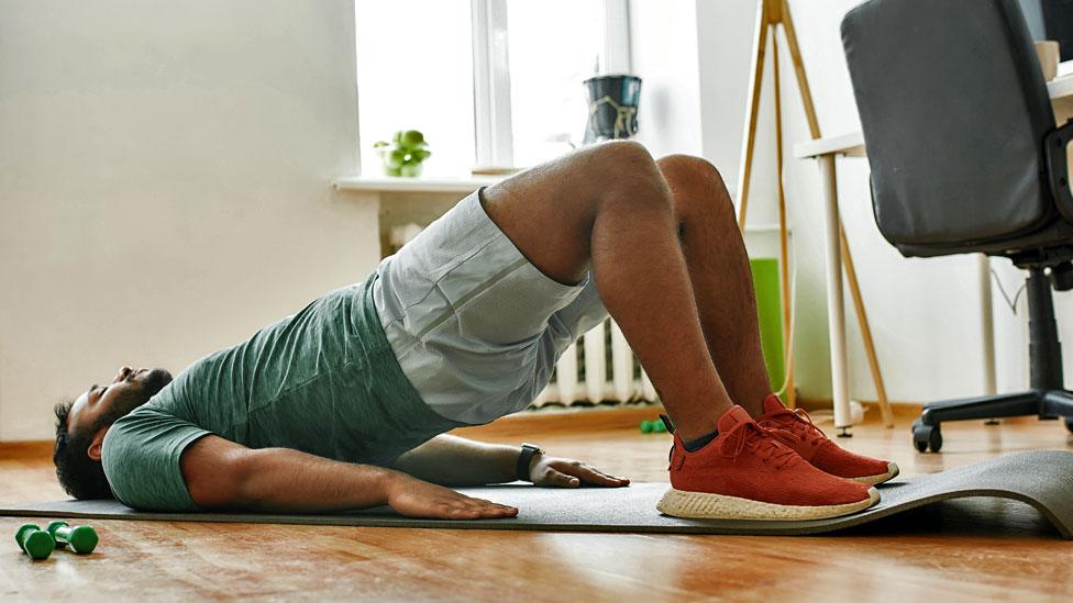 Stock image of man exercising at home