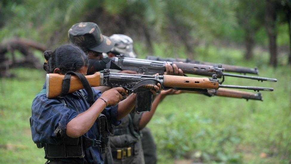 Maoist guerrillas holding guns