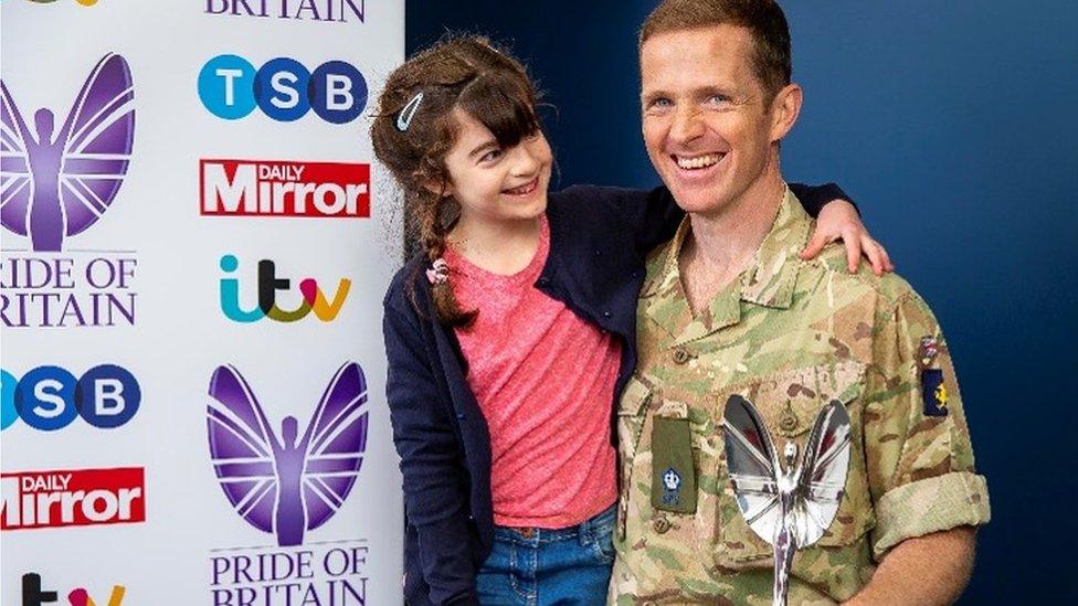 Major Chris Brannigan with his daughter Hasti and his Pride of Britain Award.