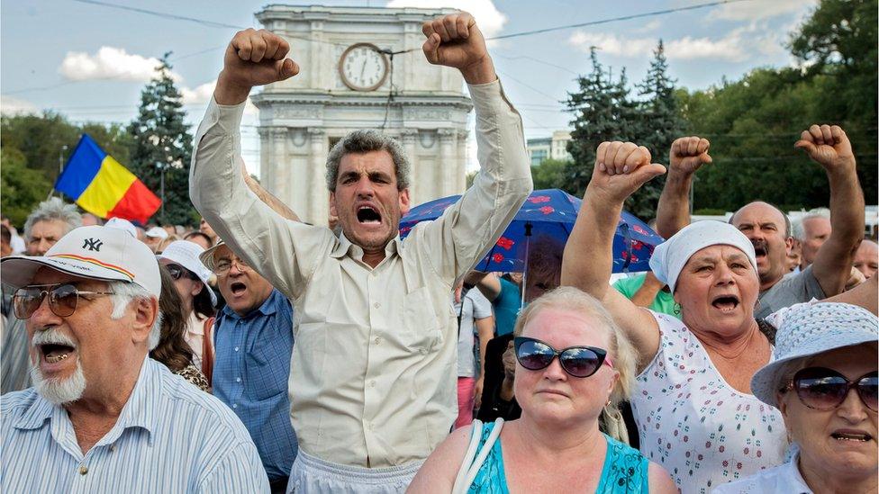 People shout anti-government slogans at the protest in Moldova