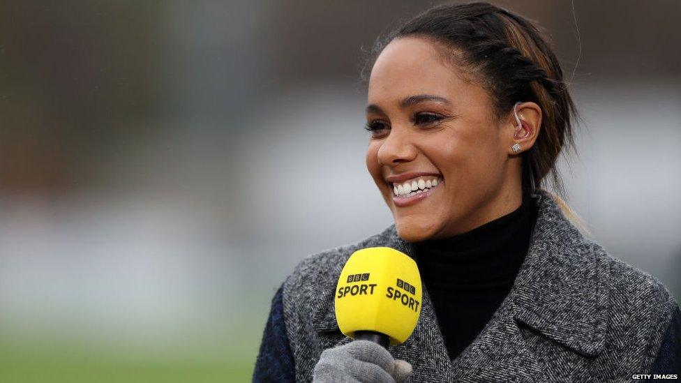 A photo of Alex Scott holding a BBC Sport microphone