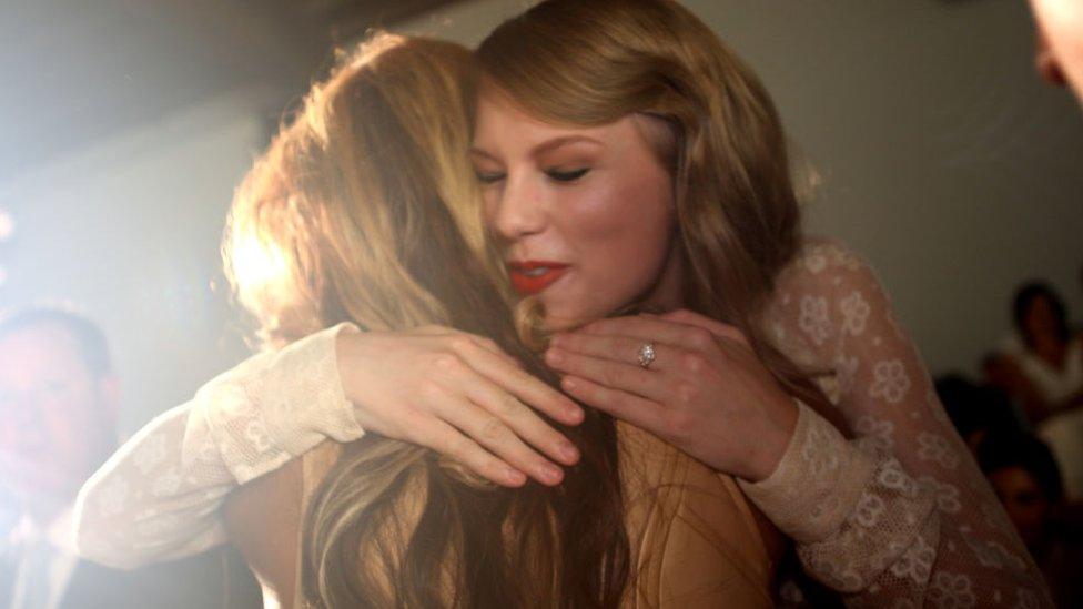 Beyonce and Taylor Swift cuddling at a fashion show in New York in 2011.