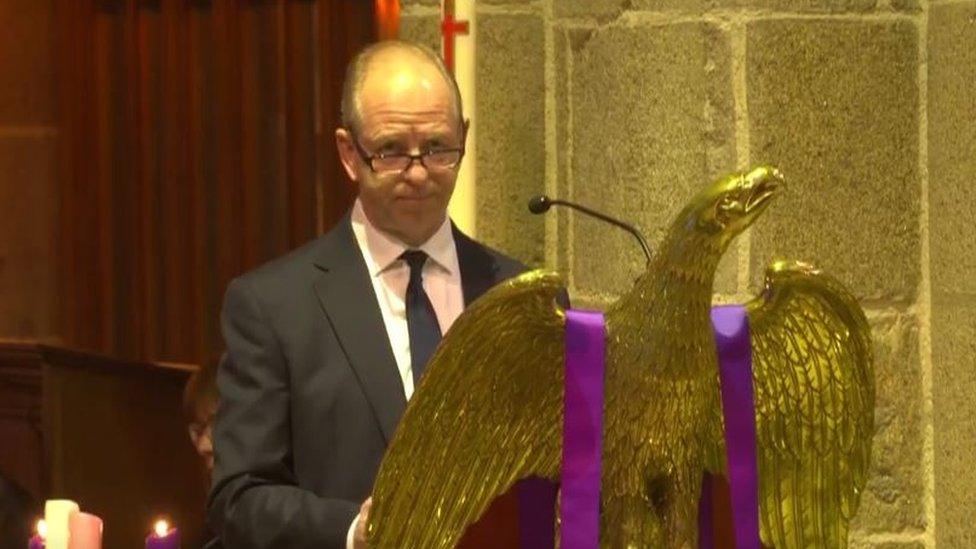 Vice Adm Jeremy Kyd CBE, Lt Governor of Jersey behind a podium in the Town Church