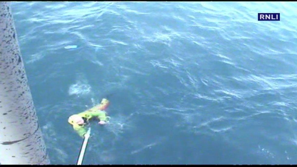 Fisherman being pulled from the water