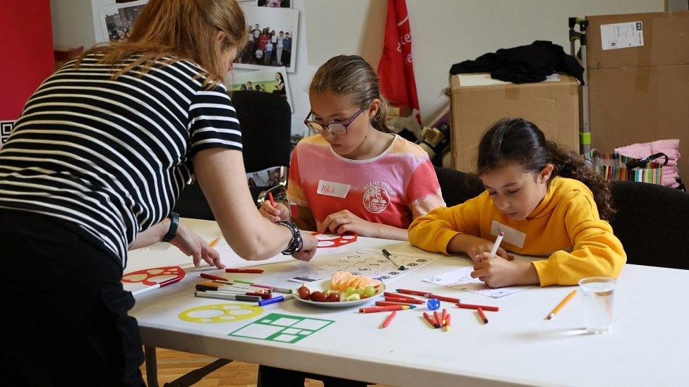 Youth work with children doing arts and crafts