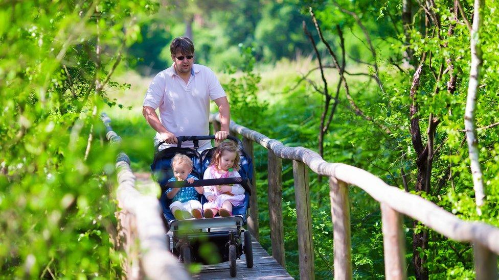 Dad pushing a double buggy