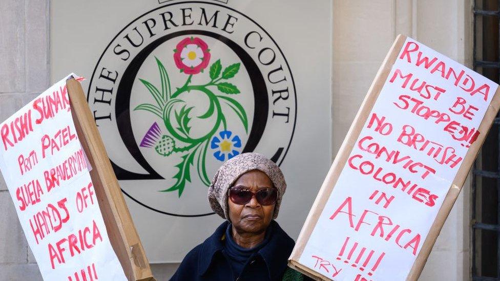 woman protesting rwandan asylum deportation outside the supreme court in london