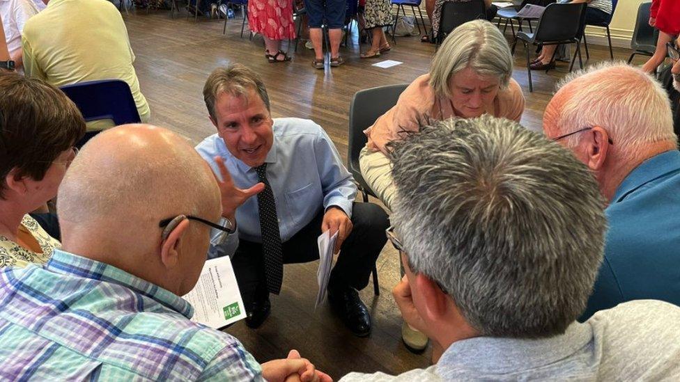 Dan Norris speaking to a group of people at a public meeting