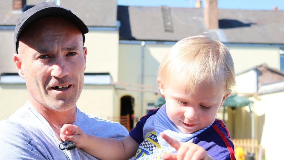 Single dad James McDaid holding his two year-old son