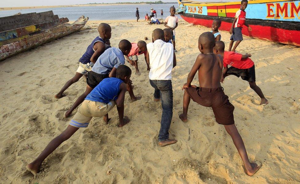 Boys doing warm up exercises on a beach in Monrovia, Liberia - Saturday 14 January 2017