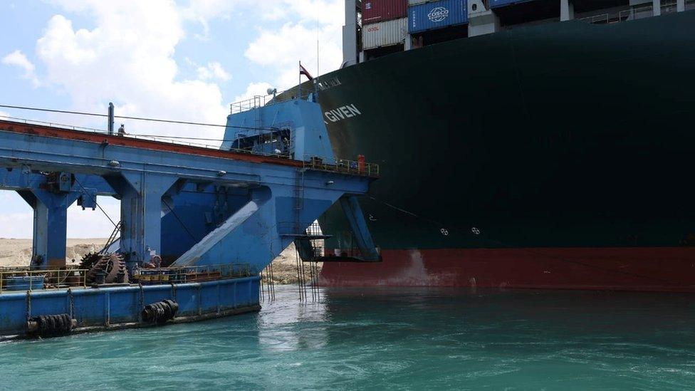 A dredging vessel attempts to refloat the Ever Given in Egypt's Suez Canal (26 March 2021)