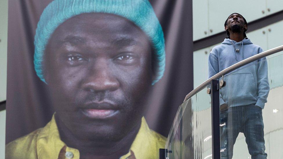 Cephas Williams with one of his photos from the Portrait of Black Britain exhibition at Manchester's Arndale Centre