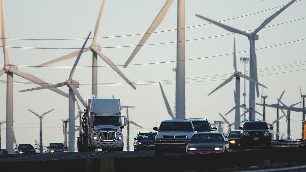 Traffic passing wind turbines in the US