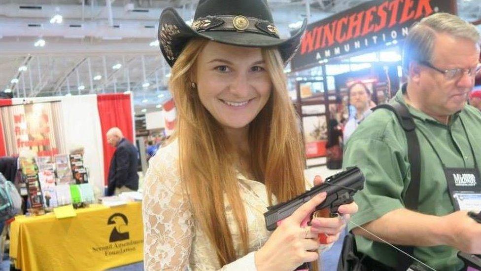 Photo of Ms Butina holding a gun