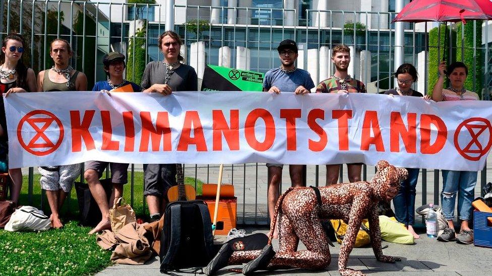 Extinction Rebellion protestors holding a banner in Germany