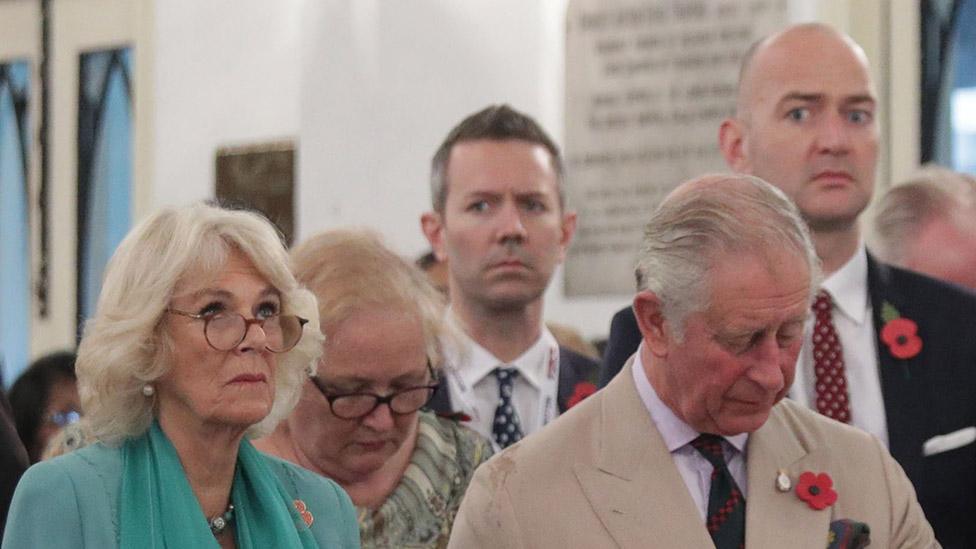 Julian Payne standing behind Charles and Camilla