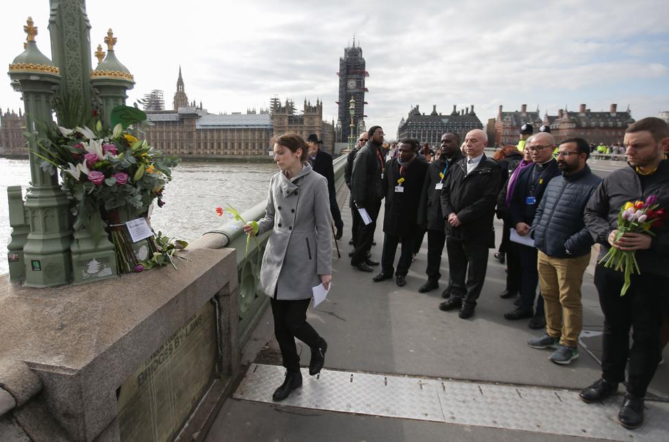 Hospital staff leave flowers on Westminster Bridge on the anniversary of the attack