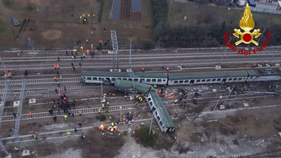 This handout picture released by the Italian Vigili del Fuoco shows firemen working on the site of a train derailment