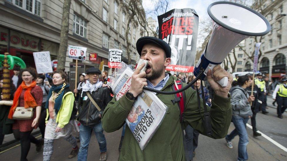 Protesters taking part in a demonstration calling for the resignation of British Prime Minister David Cameron