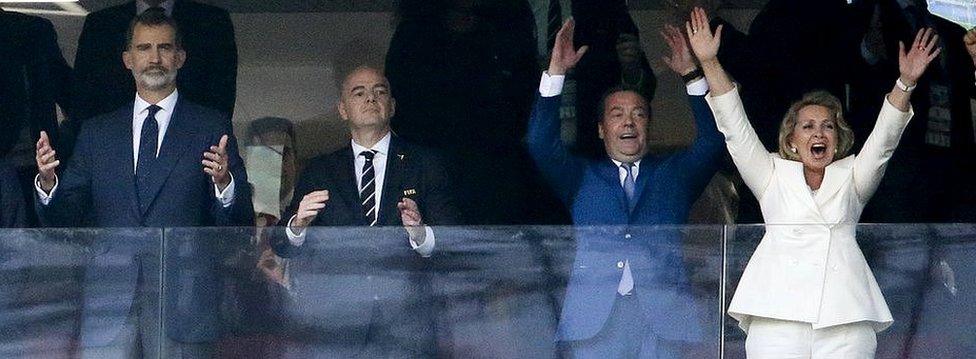 Russia's prime minister (2nd R) was all smiles, unlike Spain's King Felipe VI, as they watched Russia qualify for the quarter finals on Sunday