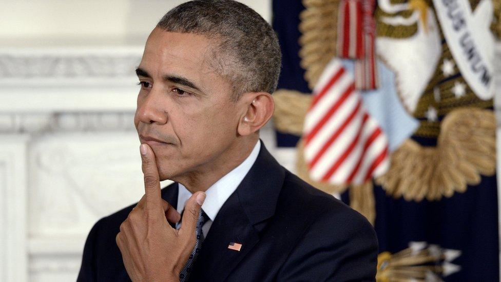 President Barack Obama touches his chin in thought.