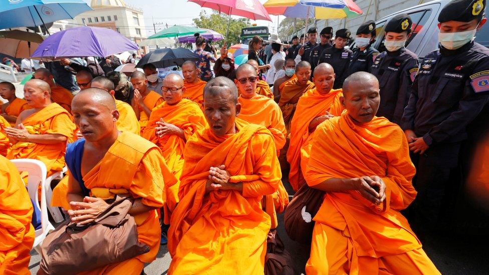 Buddhist monks chant inside Dhammakaya temple while police block access to the place in Pathum Thani province, Thailand 16 February 2017