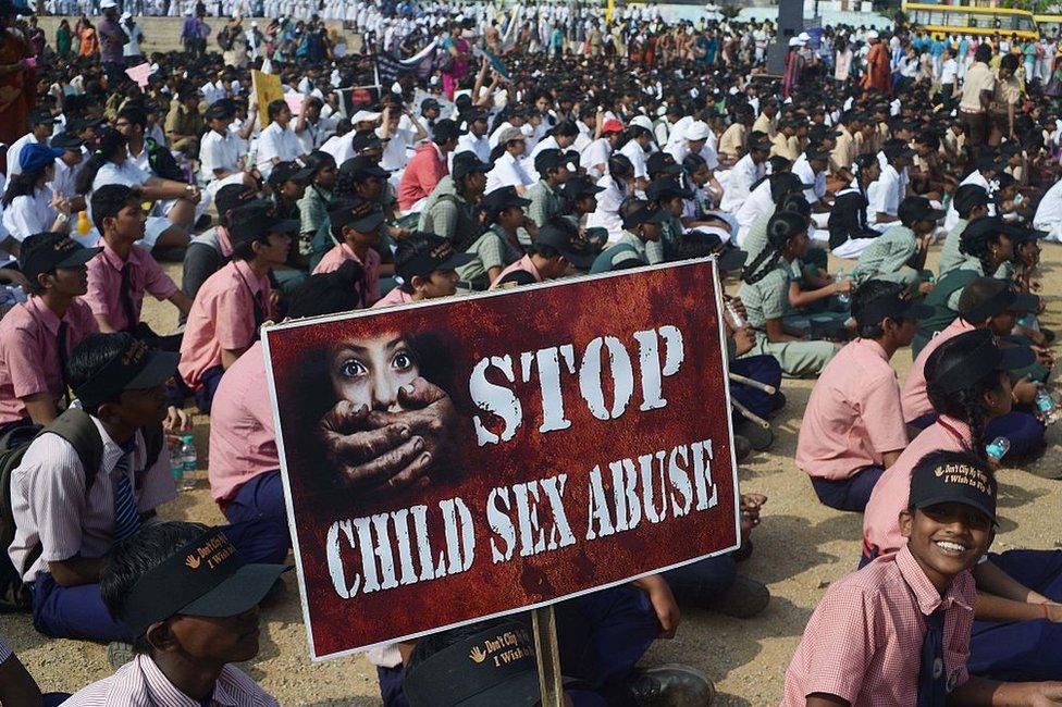 Indian school students participate in an awareness Campaign against Child Sex Abuse (CSA) in Hyderabad on November 19, 2014.