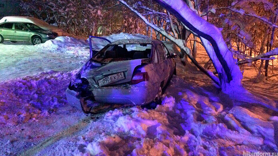 A car damaged by the stolen armoured vehicle