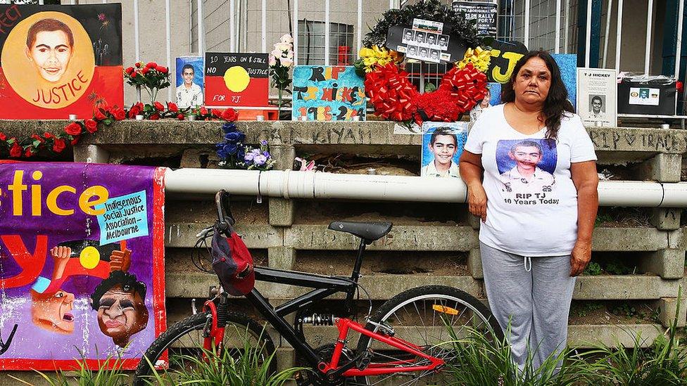 Gail Hickey stands next to a makeshift memorial for her son TJ who died during a police pursuit in 2004.