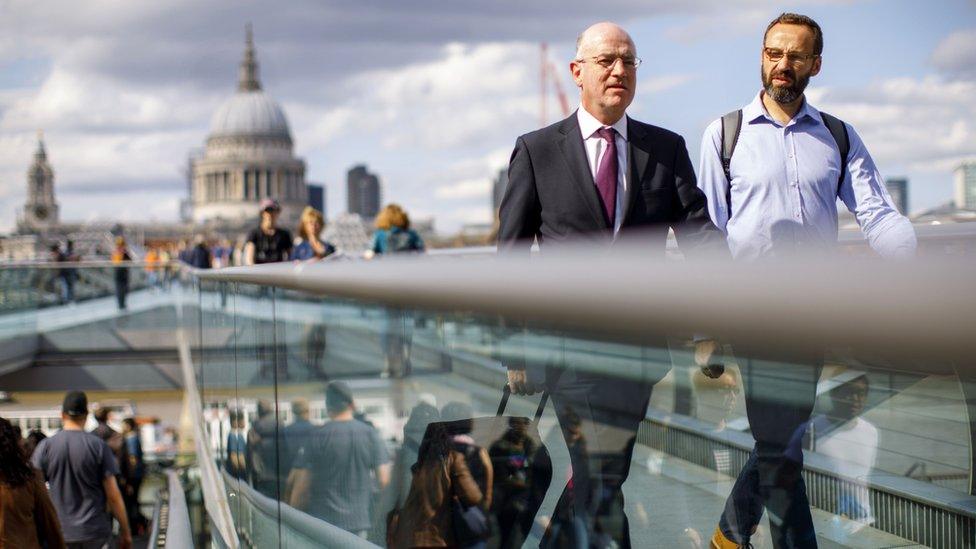 Commuters on London's Millennium Bridge