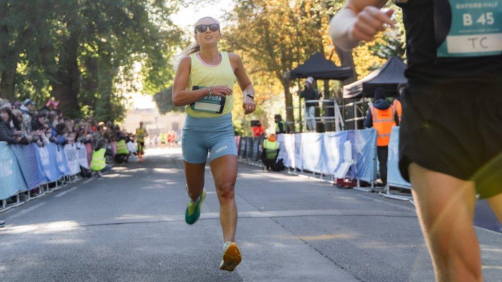 woman crossing finish line at race