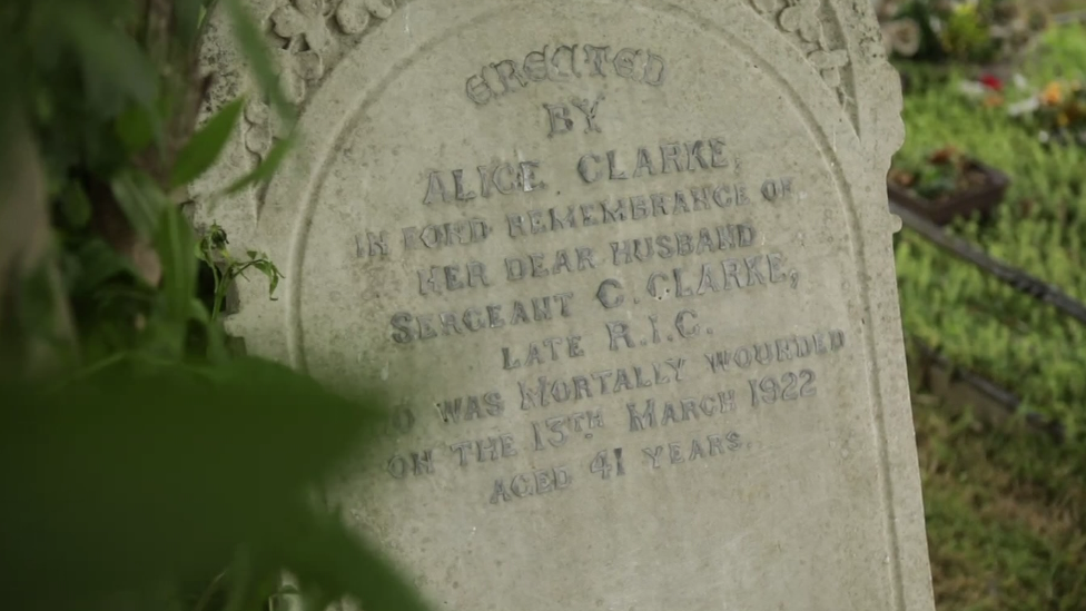 The gravestone for Sergeant Clarke, worn down from time, with a dedication from his wife Alice Clarke