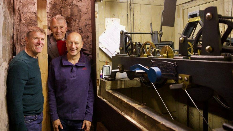 Volunteers Mike Collins, Michael Rae and Paul Morris with the mechanism