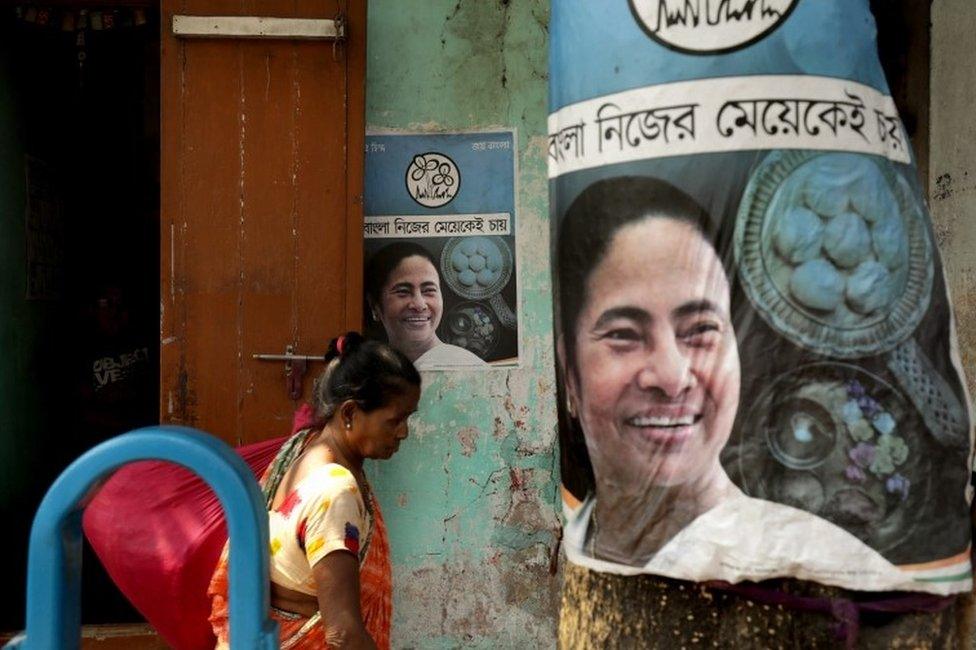 A woman walks past the election posters of All India Trinamool Congress party leader and Chief Minister of West Bengal Mamata Banerjee in Kolkata, India, 04 March 2021