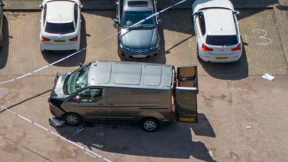 A damaged van in a street